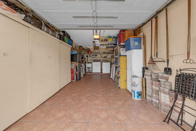 basement featuring separate washer and dryer and light tile patterned floors