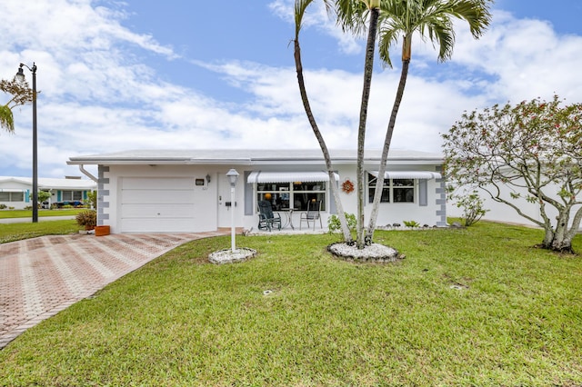 ranch-style home with a garage and a front lawn