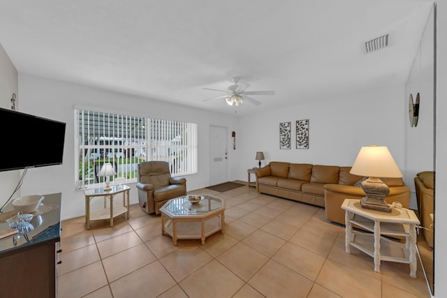 living room with light tile patterned floors and ceiling fan