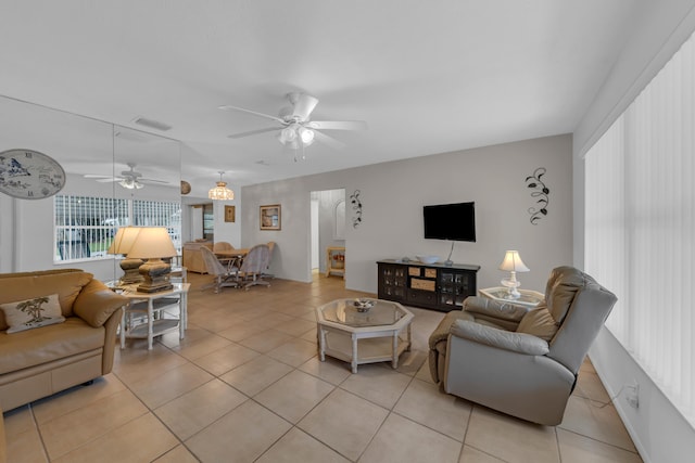 living room featuring light tile patterned floors and ceiling fan