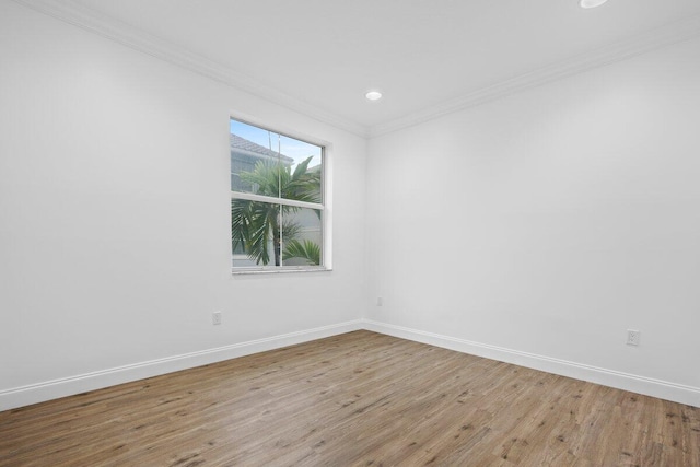 unfurnished room featuring light hardwood / wood-style flooring and crown molding