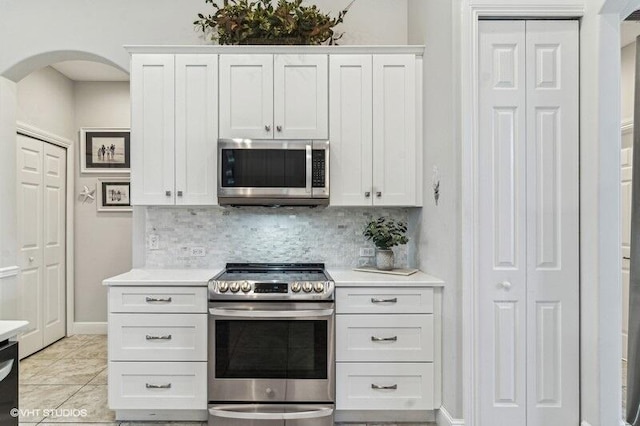 kitchen with tasteful backsplash, stainless steel appliances, and white cabinets