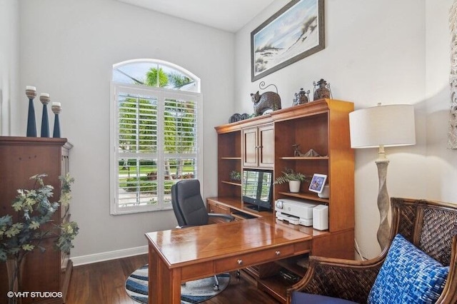 home office with dark wood-type flooring and plenty of natural light