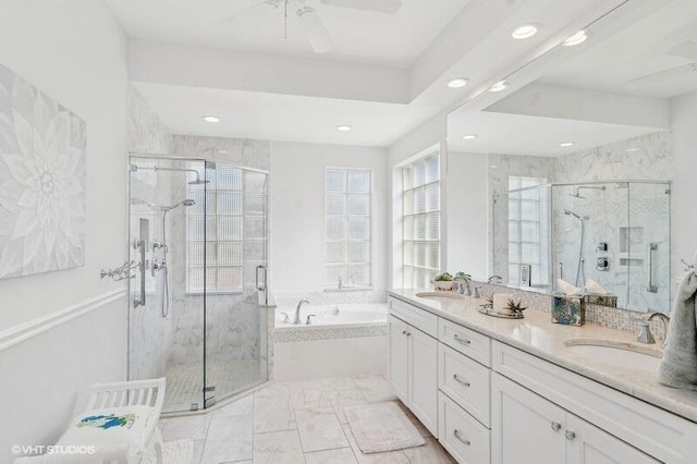 bathroom with ceiling fan, vanity, and separate shower and tub