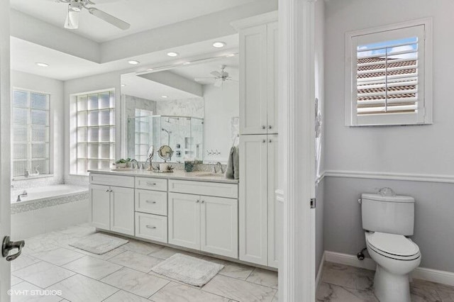 full bathroom with independent shower and bath, vanity, ceiling fan, and toilet