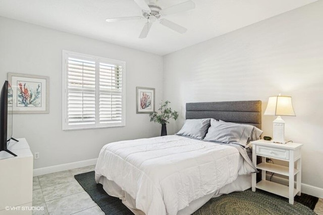 tiled bedroom featuring ceiling fan