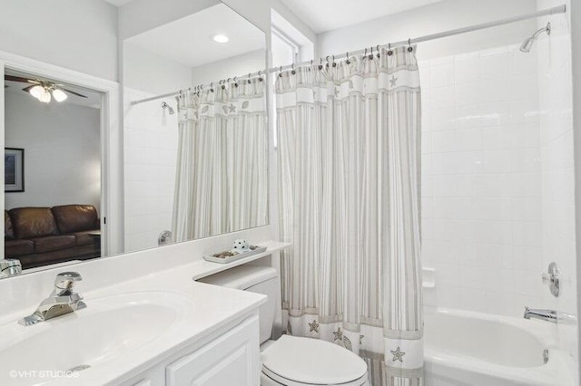 full bathroom featuring vanity, ceiling fan, shower / bath combination with curtain, and toilet