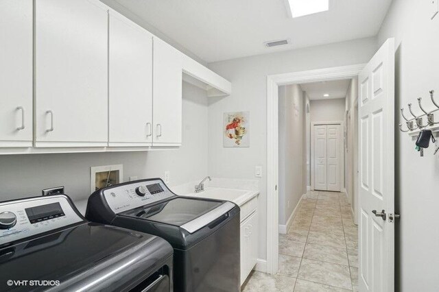 laundry area with sink, cabinets, washer and dryer, and light tile patterned flooring