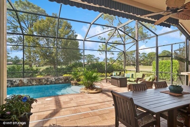 view of swimming pool with an outdoor living space, a lanai, a patio area, and ceiling fan