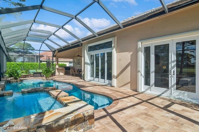 view of pool featuring an in ground hot tub, glass enclosure, a patio, and french doors