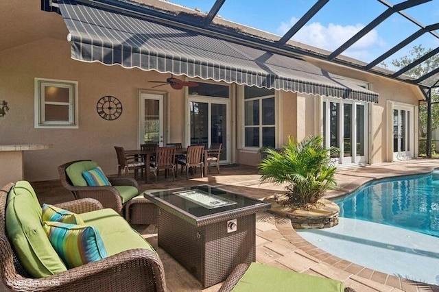 rear view of house featuring an outdoor living space with a fire pit, ceiling fan, and a patio area