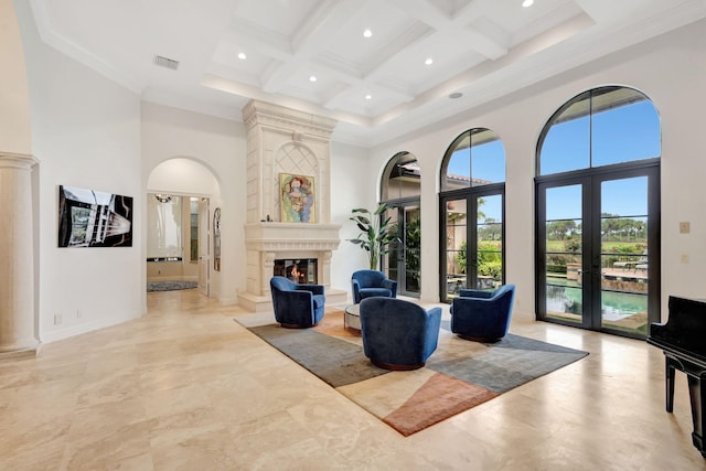 living room with french doors, beamed ceiling, coffered ceiling, and a high ceiling