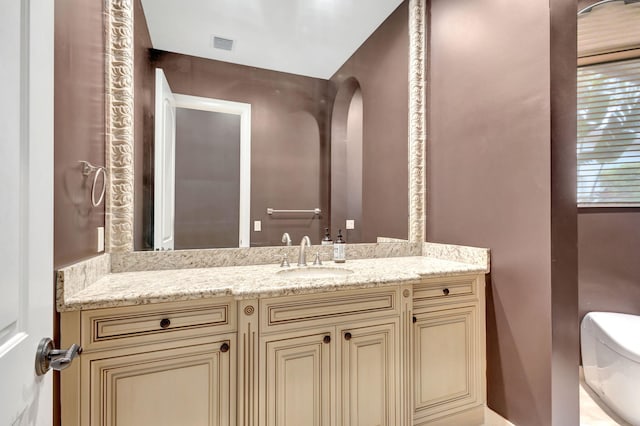 bathroom with vanity and toilet