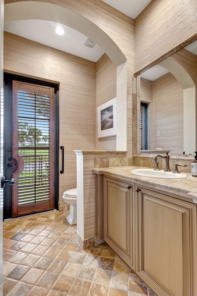 bathroom featuring vanity and toilet