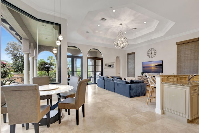 dining area with a chandelier, ornamental molding, a raised ceiling, and sink