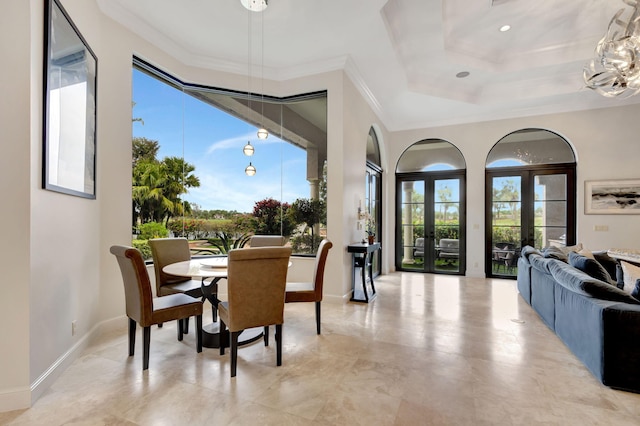 dining area with crown molding, a chandelier, and french doors