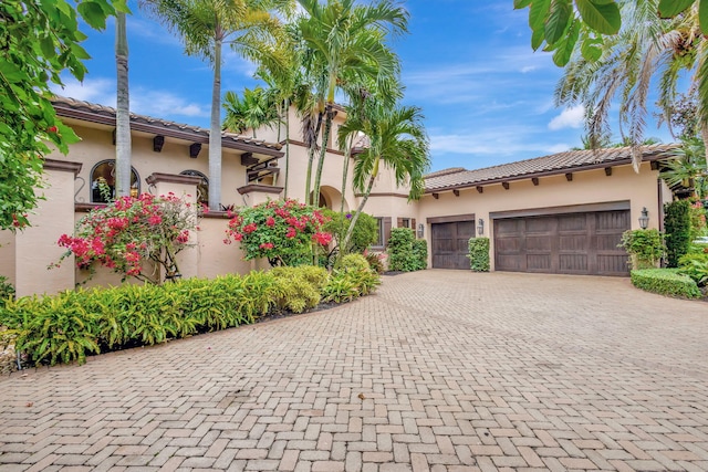 mediterranean / spanish-style house with a garage