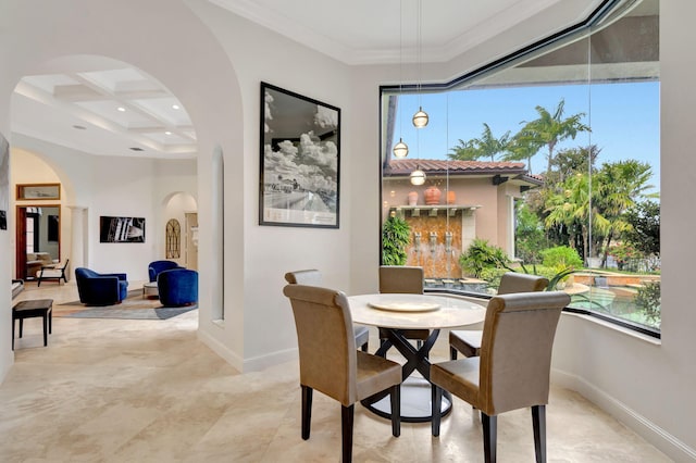 dining room with beamed ceiling, ornamental molding, coffered ceiling, and a high ceiling