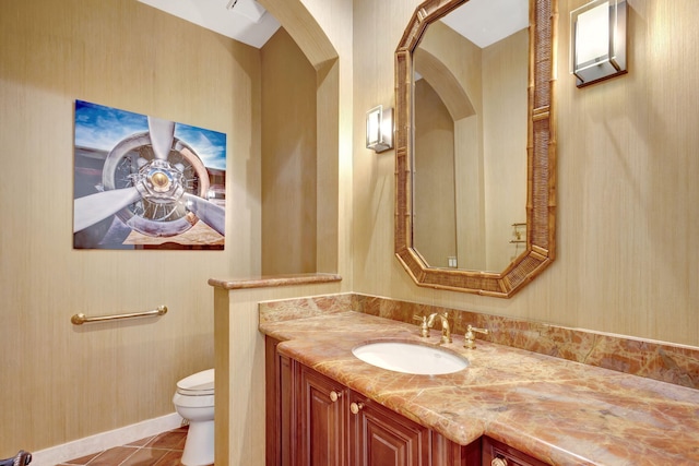 bathroom featuring vanity, tile patterned floors, and toilet