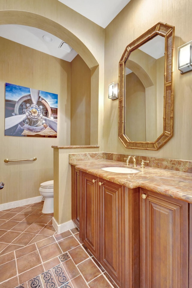 bathroom featuring vanity, tile patterned floors, ceiling fan, and toilet