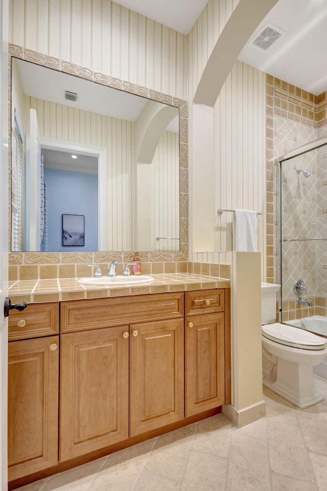 bathroom featuring vanity, toilet, and a bidet