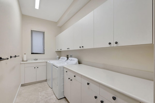 washroom featuring cabinets, separate washer and dryer, and sink