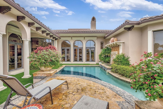 view of swimming pool with a patio area and french doors