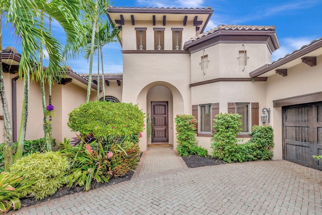 view of exterior entry with a garage