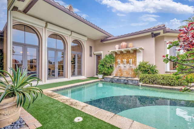 view of swimming pool featuring french doors