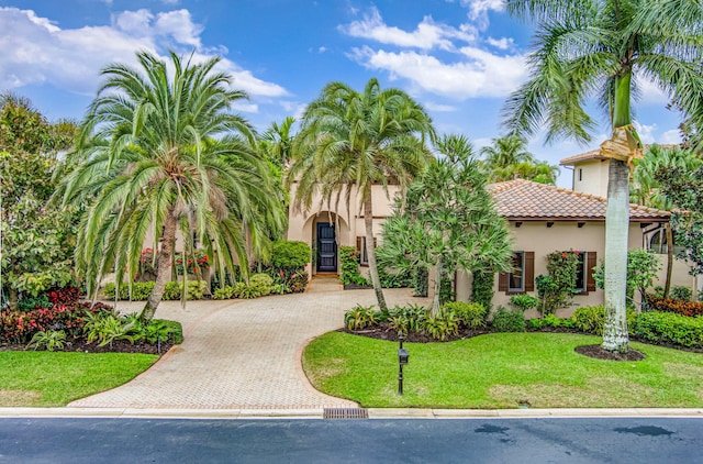 mediterranean / spanish-style house featuring a front lawn