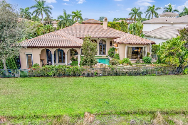 mediterranean / spanish home featuring a front yard