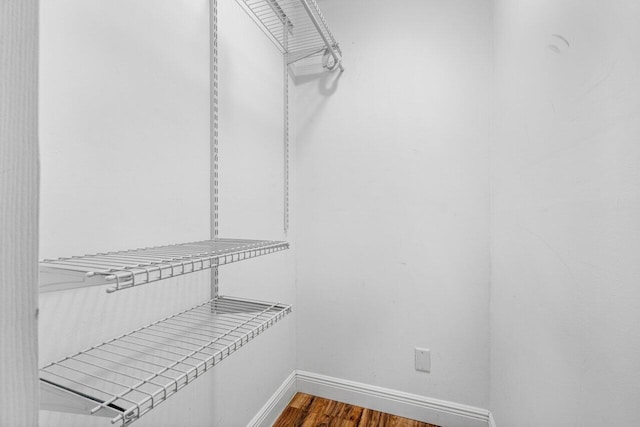 spacious closet with dark hardwood / wood-style floors