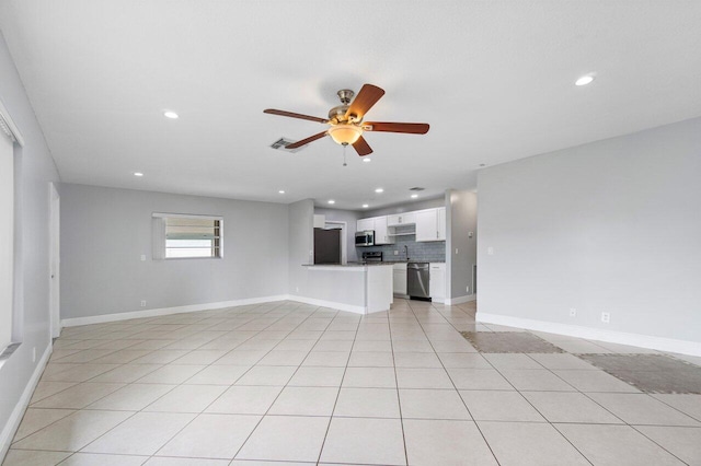 unfurnished living room featuring ceiling fan and light tile patterned floors