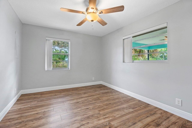 spare room with hardwood / wood-style flooring, ceiling fan, and a textured ceiling