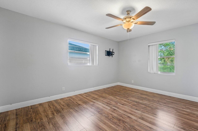 spare room featuring hardwood / wood-style flooring, a textured ceiling, and ceiling fan