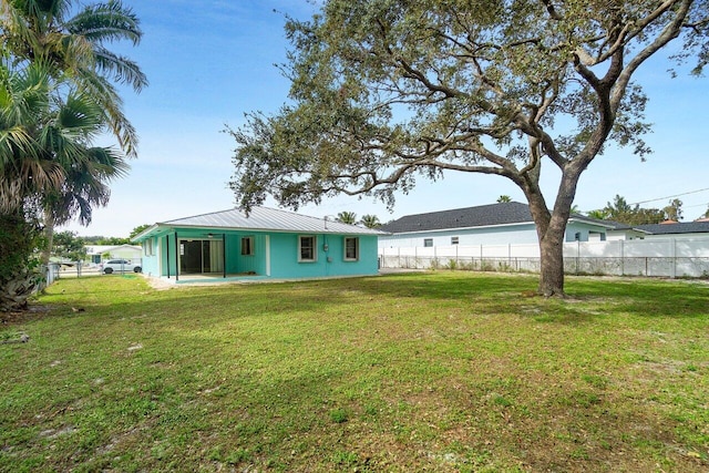 rear view of property featuring a yard