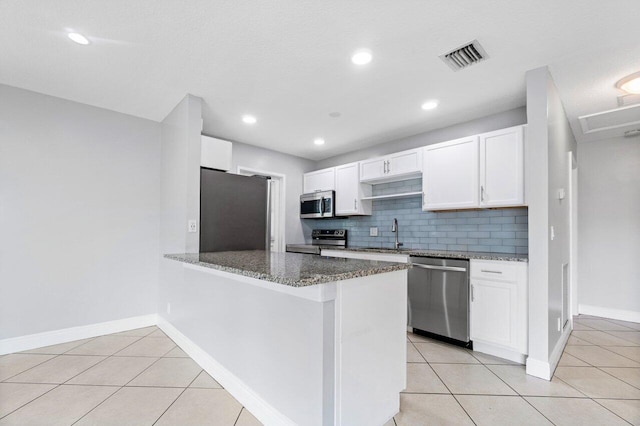 kitchen with light tile patterned floors, white cabinets, and appliances with stainless steel finishes