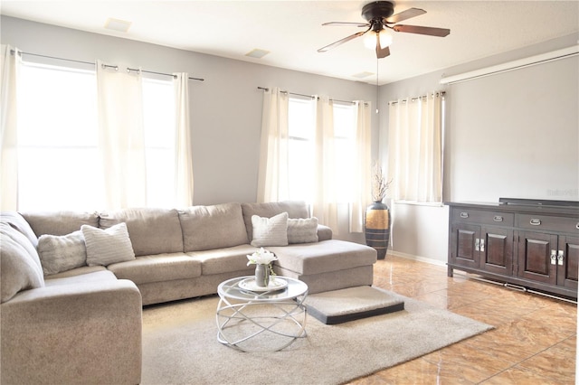 tiled living room with ceiling fan and plenty of natural light