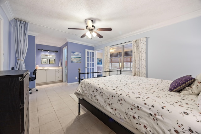 bedroom with light tile patterned floors, crown molding, ensuite bath, ceiling fan, and a textured ceiling