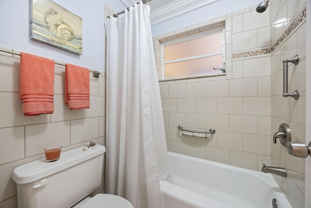 bathroom featuring shower / bathtub combination with curtain and toilet