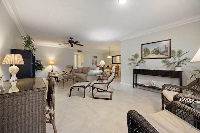 living room featuring a ceiling fan, light tile patterned flooring, crown molding, and baseboards