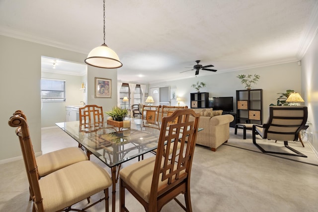 dining space with crown molding and ceiling fan