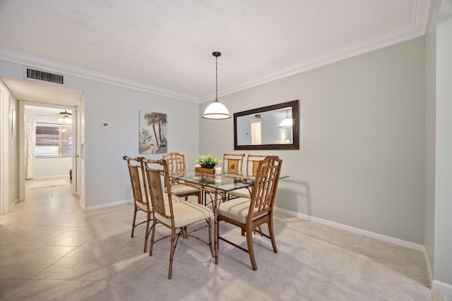 dining area featuring light tile patterned floors and crown molding