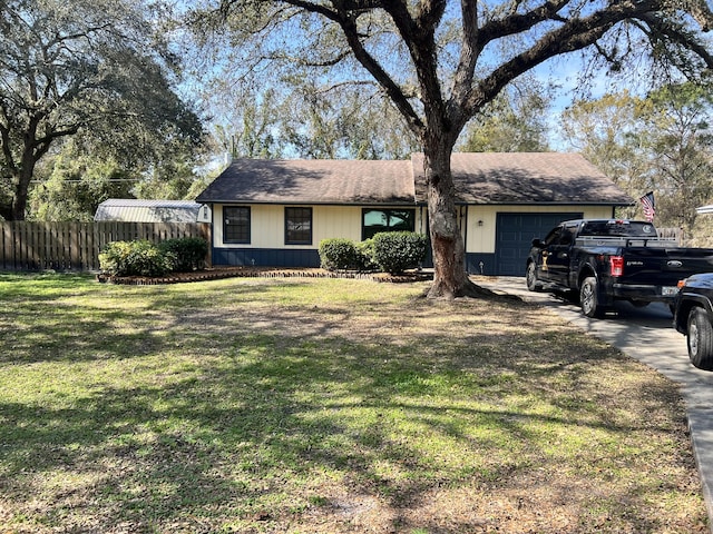 ranch-style house featuring a garage, fence, a front lawn, and concrete driveway