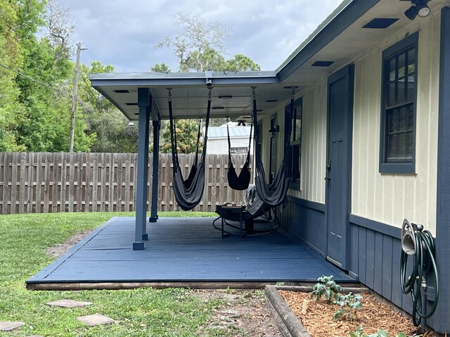 view of patio with fence and a wooden deck