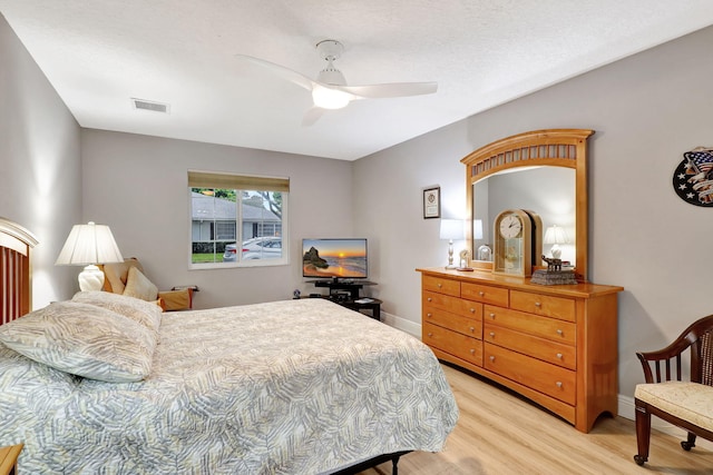 bedroom with ceiling fan and light hardwood / wood-style floors