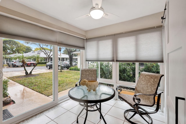 sunroom featuring ceiling fan and a healthy amount of sunlight