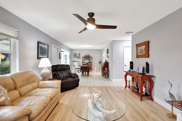 living room featuring ceiling fan and light hardwood / wood-style floors