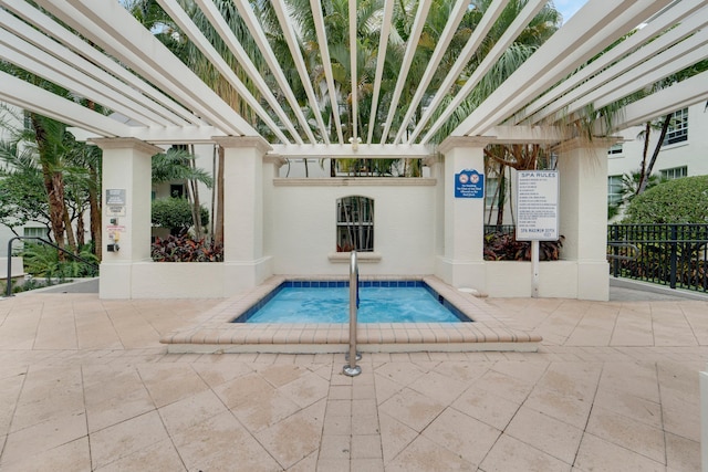 view of pool with a patio, a pergola, and a hot tub