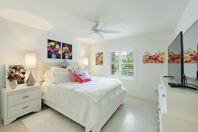 tiled bedroom featuring ceiling fan